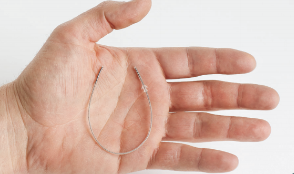 StimRouter flexible lead resting across a hand with the stimulating and receiver ends visible.